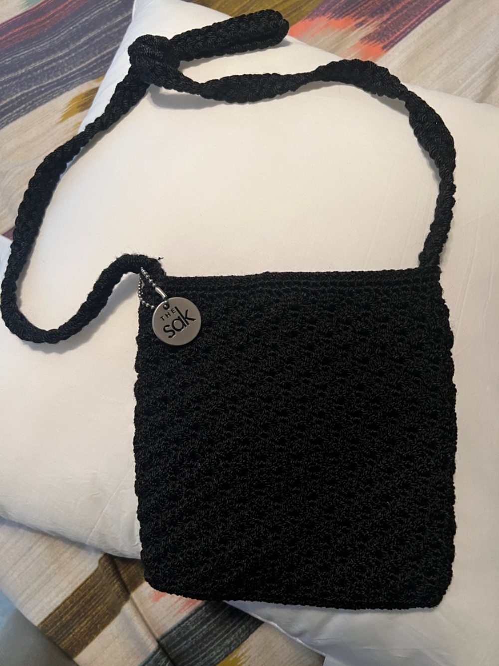 The Sak Black Crochet Small Crossbody with Logo Charm